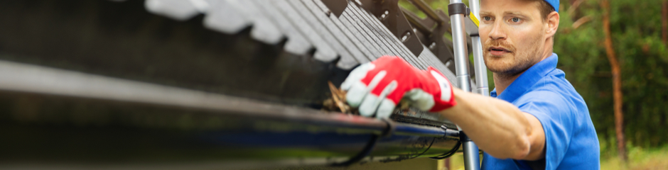 Man cleaning gutters