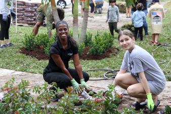 A young adult and Cinch employee helping with the landscaping during the Homes for Our Troops event