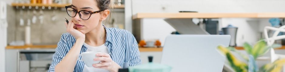 A woman with a coffee sitting pensively