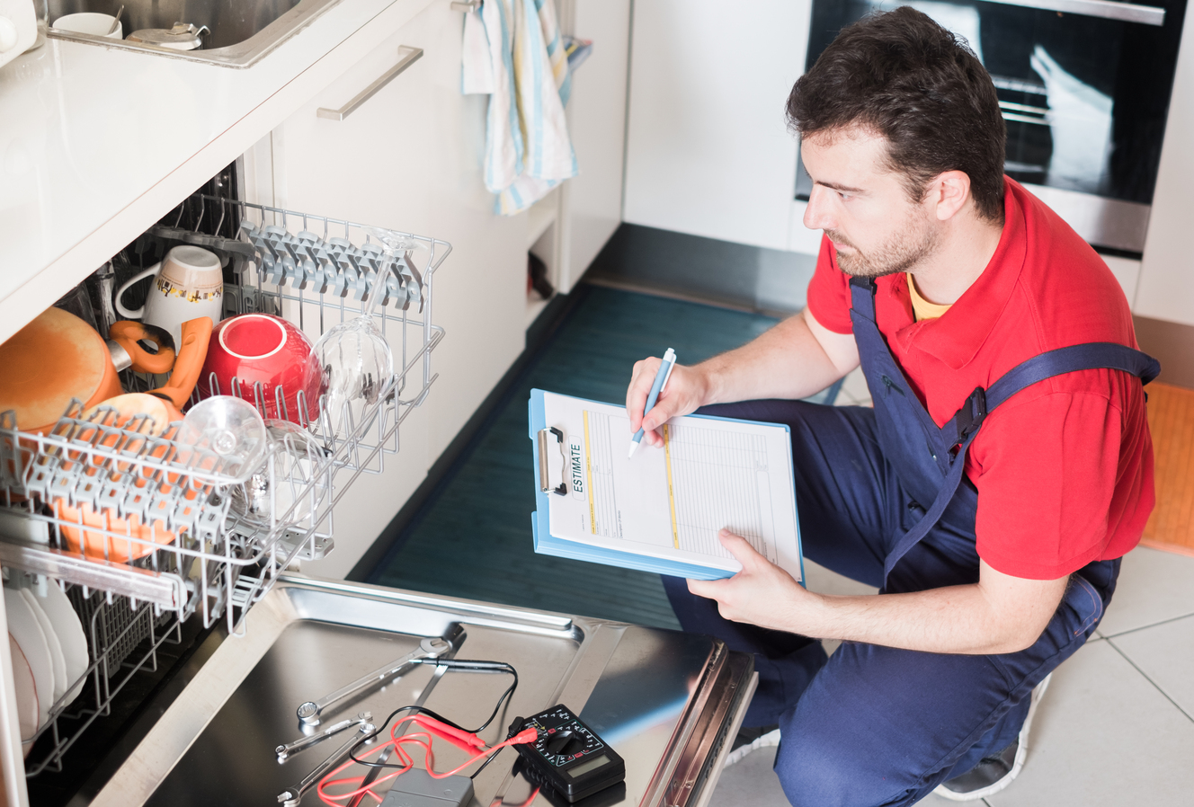 Technician estimating cost for broken dishwasher that has appliance warranty