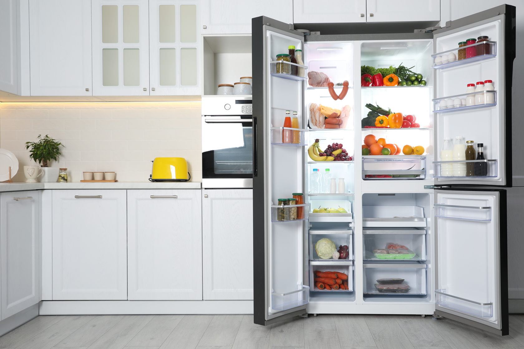 Two-door refrigerator open and filled with food