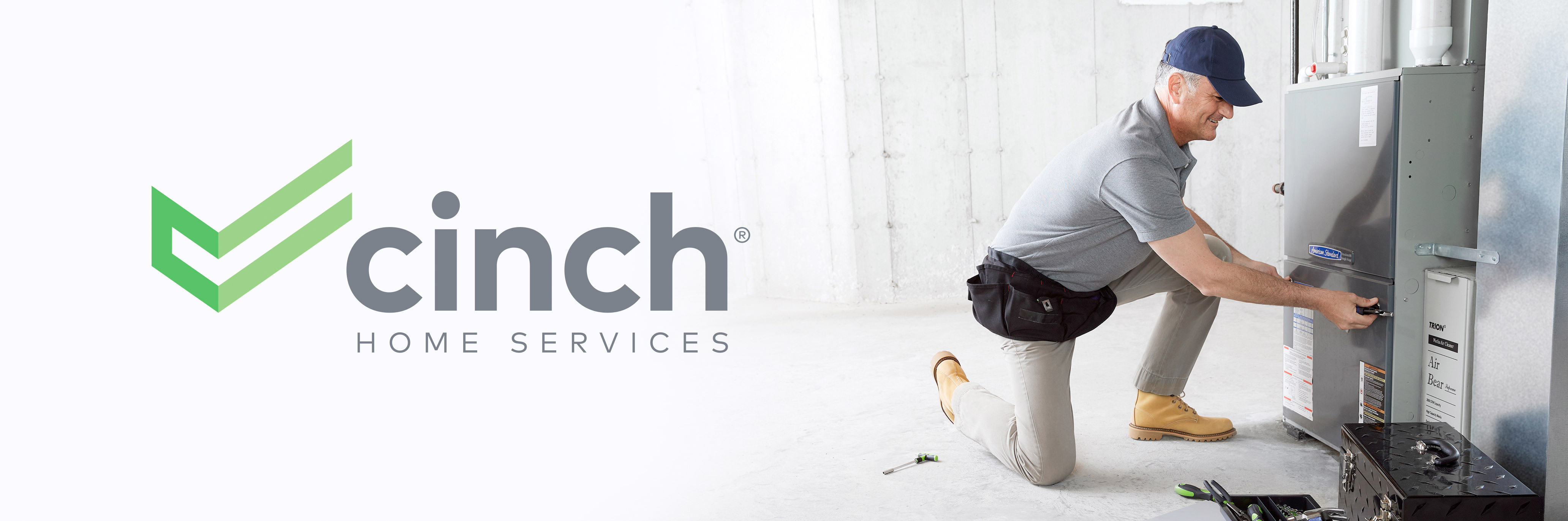 Cinch logo with a repairman in a gray shirt and pants and navy blue hat fixing an A/C unit