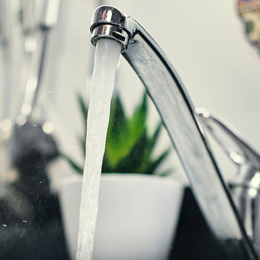 Running faucet into a a kitchen sink