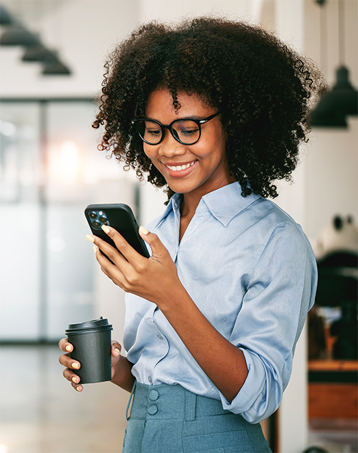 Young woman smiling at mobile phone