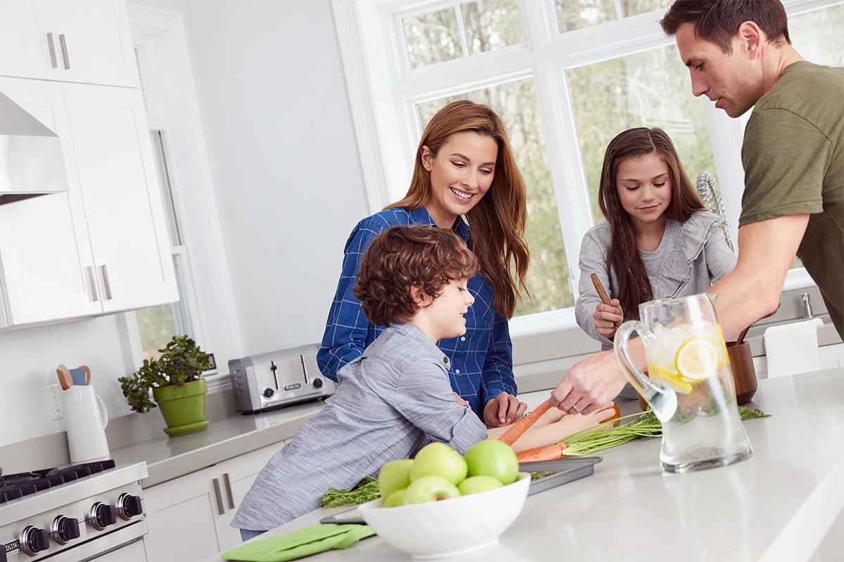 Young family cooking a meal in the kitchen