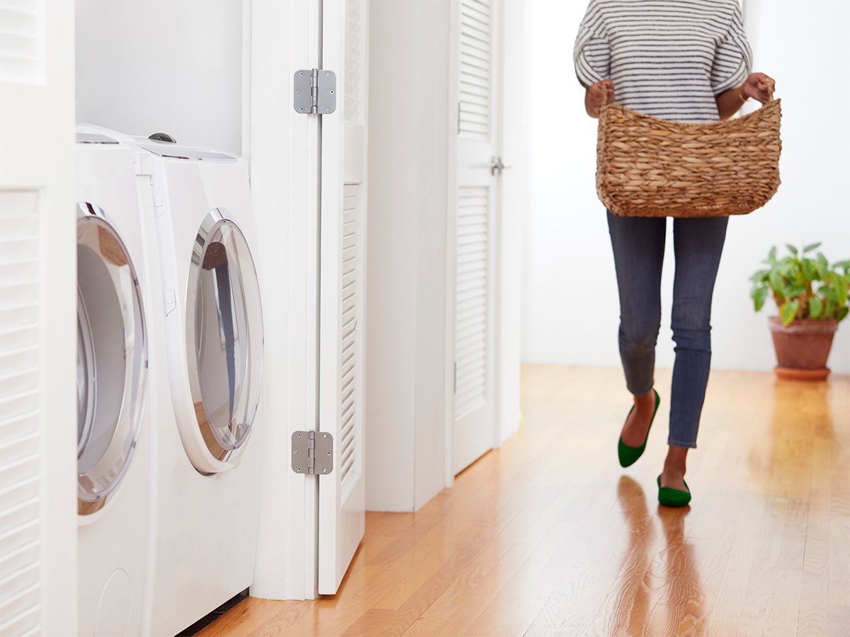 Woman walking to laundry room with basket
