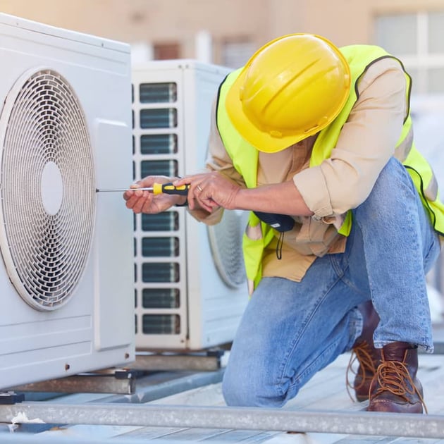 Home warranty in Utah - Service technician fixing an appliance