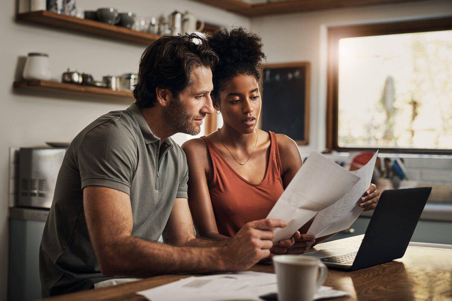 A young couple discussing how they accrued so many costs for home repairs
